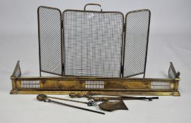 A collection of brass fireside items, including a fender,