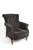 A large button back armchair, upholstered in a black/brown Mulberry Company fabric,