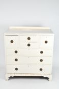 A 20th century pine chest of drawers, later painted white,