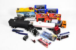 A selection of model vehicles, consisting mostly trucks and trailers,