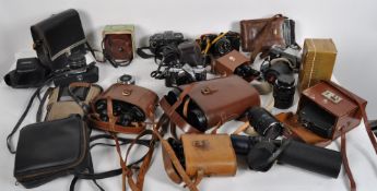A large quantity of 20th century cameras, some in leather cases,