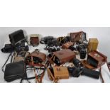 A large quantity of 20th century cameras, some in leather cases,