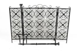 A three-fold, wrought iron, black lacquered fire screen together with a fork and poker
