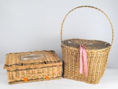 Two wicker baskets, both with lids and handles to the top,