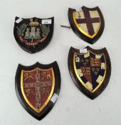 A group of four early 20th century armorial shields, each painted in enamels and gilt,
