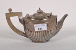A silver teapot with stop fluted decoration, hallmarked Birmingham 1972,