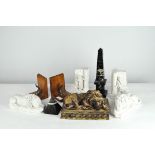 Two pairs of bookends together with three models of reclining lions, a stone obelisk and a pyramid