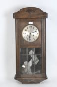 A 20th Century oak cased wall clock, silvered dial with Arabic numerals,