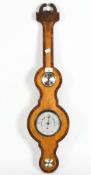 A wheel barometer in an inlaid wood case with open pediment, with temperature dial,