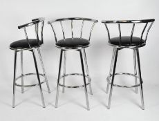 Three chrome bar stools with black padded seat,