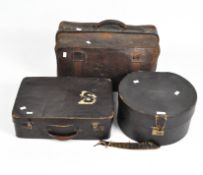 Two brown leather cases together with a black leather hat box