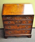 A reproduction bureau, mahogany veneer, the drop front revealing fitted interior,