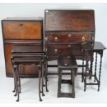 A selection of assorted furniture including an oak bureau, nest of three tables,