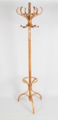 A contemporary pine coat stand, with six hooks and a tripod foot,