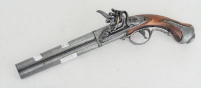 A reproduction flinktlock style pistol, with wooden and metal grip,