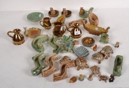 A collection of Wade ceramics, including tortoises, miniature planters,
