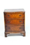 A reproduction bow front chest of three drawers with profile rims,