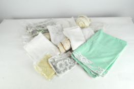 A selection of vintage fabric, including crochet edgings, napkins and tablecloths,