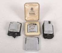 A collection of four lighters including a Ronson Varaflame,