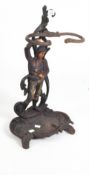 An early 20th century cast iron umbrella stand in the form of a country youth,