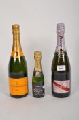 A bottle of G.H.Mumm champagne with a bottle of Veuve Clicquot Ponsardin and a Lanson champagne