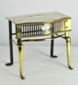 An ornate brass trivet stand, with pierced grill to front, on flowing feet