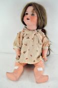 An Armand Marseille early 20th century doll with bisque head stamped Koppelsdorf Germany 1330 A 7 M,