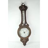 A early 20th Century oak cased banjo aneroid barometer, with thermometer to stem,