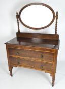 An oak dressing table, late 19th century, with oval mirror supported on barley twist uprights,