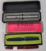Three Parker fountain pens, two in boxes, including a 1975 blue fountain pen,