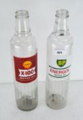A Shell X-100 Motor Oil glass bottle and a BP Energol Motor Oil glass bottle,