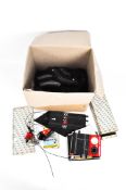A selection of Scalextric track together with albums, a lap counter and other accessories