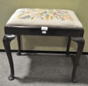 A 20th century floral embroidered piano stool, on a stained wood base,