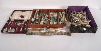 A selection of silver plated flatware, comprising sugar tongs, knives, forks, teaspoons and more,