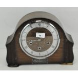 A 20th century oak mantel clock, with silvered chapter ring, Roman numerals and a Smiths movement,