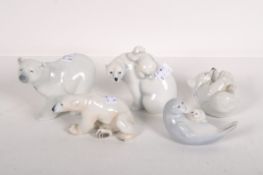 Five ceramic models of polar bears, in assorted poses, including examples by Royal Worcester,