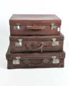Three vintage brown leather suitcases, with metal fittings and locks,