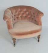 A late 19th/early 20th century button back upholstered armchair,