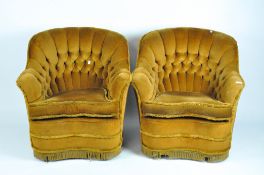 A pair of button back armchairs upholstered in dark mustard velour,