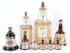 A collection of Bell's whisky decanters