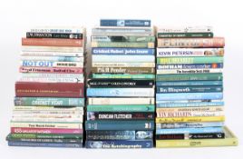 A library of cricket related books, including Henry Blofeld,