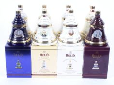 A collection of eight boxed Bell's whisky commemorative Christmas decanters and their contents,