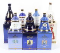 A collection of seven boxed Bell's Whisky Royal Commemorative decanters and contents,