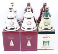 A collection of six boxed Bell's whisky commemorative Christmas decanters and their contents,
