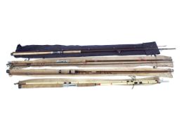 Four fishing rods, including: a 10’ Bruce and Walker spinning rod, a Martin James 2 piece sea rod,