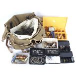 A canvas tackle bag with contents including sea fishing weights and boxes of Trout flies and