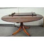 A mahogany oval table with leaf, raised