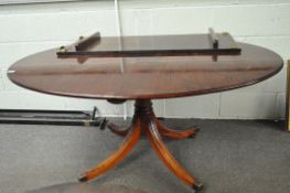 A mahogany oval table with leaf, raised