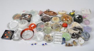 A collection of glass paperweights, including examples by Caithness and Mdina,