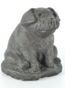 A contemporary stone model of pig, in a seated pose with bronzed effect glaze,